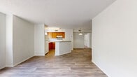 Located at 2271 Weston Ln in Orlando, FL, this single-floor residence offers two bedrooms and two bathrooms in a well-organized, functional layout. The open-concept living and kitchen area forms the heart of the home, where light wood-look flooring flows throughout and a textured ceiling adds subtle character. The kitchen features warm honey-toned wood cabinetry, a peninsula with a light stone-style countertop ideal for casual dining or food prep, a tile backsplash, and white appliances including a refrigerator and range. A pendant light fixture accents the space and connects it seamlessly to the living area.

Large windows in the living room invite natural light and offer views of surrounding greenery, creating a bright and airy atmosphere. The two bedrooms are carpeted for comfort and each includes a window with natural light and access to dedicated closet space. The closets feature wire shelving systems for organized storage. The bathrooms are clean and functional, with one featuring a tiled walk-in shower. The primary bedroom provides a comfortable, well-sized retreat. Throughout the home, a neutral color palette of whites and soft grays creates a cohesive, move-in-ready environment suitable for a variety of living arrangements.