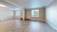 Located at 2886 S Circle Dr in Colorado Springs, CO, this well-appointed one-bedroom, two-bathroom unit offers a thoughtfully designed single-floor layout. Light-toned wood-look flooring flows consistently throughout the space, complemented by crown molding that adds a refined touch to every room.

The open kitchen features an expansive run of white shaker-style cabinetry topped with granite countertops, a tile backsplash, a stainless steel refrigerator, and recessed lighting — providing ample prep and storage space. The living area is generously sized, bathed in natural light from multiple windows adorned with white blinds that frame views of surrounding greenery. Wall-mounted HVAC units ensure year-round comfort.

The spacious primary bedroom offers a bright, open atmosphere with large windows and a built-in granite-topped vanity nook with gold-framed mirror and wall sconces. The two bathrooms are well-appointed: one features a dual-sink vanity with granite countertops, white cabinetry, gold-framed mirrors, and recessed lighting, while the second includes a tub/shower combination with elegant marble-style tile surround. The overall aesthetic is clean, modern, and move-in ready.