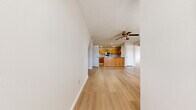 Located at 1430 Trumbull Avenue in Normal, IL, this single-floor, 3-bedroom, 2-bathroom home offers a practical and comfortable layout across a well-utilized footprint. The open-concept living and dining areas flow seamlessly toward the kitchen, all unified by light wood laminate flooring and crisp white walls that lend a clean, bright ambiance. A ceiling fan is centrally positioned overhead, adding to the airy feel of the main living space.

The kitchen is a functional highlight, featuring warm honey-toned oak cabinetry, light countertops, and a full suite of stainless steel appliances including a range, over-the-range microwave, and dishwasher. A peninsula provides additional prep space and visually connects the kitchen to the living area.

The generously sized primary bedroom includes its own vanity area with warm wood cabinetry and a large mirror, as well as a walk-in closet. The additional bedrooms are well-proportioned, each with closet space and light wood flooring. One bedroom features vaulted ceiling angles, adding architectural character. The bathrooms are clean and functional, with one featuring a full tub-shower combo. A connecting hallway ties all rooms together efficiently throughout the single-level floor plan.