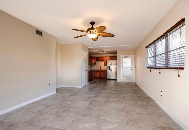 Living room facing front entry door kitchen dinning room - 4608 SE 6th Ave
