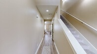 Located at 101 Tuscany Cir in Maumelle, Arkansas, this two-story home offers a thoughtfully designed layout spread across two floors. The main level features a bright and welcoming living room with hardwood-style flooring, crown molding, a ceiling fan, a cozy fireplace, and a large window that fills the space with natural light. The kitchen is a standout, showcasing warm wood cabinetry, granite countertops, stainless steel appliances, a breakfast bar, and a graceful arched passthrough connecting it to the living area. A dedicated dining nook with a chandelier and tile flooring completes the open-concept feel. A hallway with recessed lighting and an arched accent leads to additional main-floor rooms, including a laundry room equipped with a full-size washer and dryer. Upstairs, the spacious primary bedroom features plush carpet, a ceiling fan, and direct access to an en-suite bathroom with ample cabinetry. The second bedroom impresses with vaulted ceilings and a striking arched window that invites abundant natural light. Three bathrooms in total serve the home, including a full bath with a tub-shower combo and tile flooring. Multiple closets throughout provide generous storage across both levels.