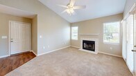 Located in Foley, Alabama, this one-bedroom, one-bathroom residence offers a thoughtfully designed layout that maximizes comfort and functionality. The open-concept living and dining area immediately impresses with soaring vaulted ceilings, a ceiling fan, and a tile-surround fireplace that serves as a natural focal point. Plush carpeting flows throughout the living spaces, while multiple windows invite an abundance of natural light and views of the surrounding greenery.

The kitchen is efficiently arranged with crisp white cabinetry, white countertops, and a full suite of black appliances, including a refrigerator, electric range, built-in microwave, and dishwasher. Warm wood-look flooring grounds the space and complements the clean cabinetry aesthetic.

The generously sized primary bedroom features vaulted ceilings, a ceiling fan, and soft carpet underfoot. A window provides natural light, and a dedicated closet offers organized storage. French doors in the living area open to an outdoor area, enhancing the connection to the outdoors.

The bathroom is clean and functional, equipped with a full tub-shower combination, wood-look flooring, and neutral finishes. A hallway connects the living areas to the private quarters, completing this well-organized and comfortable home.