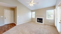 Located in Foley, Alabama, this one-bedroom, one-bathroom residence offers a thoughtfully designed layout that maximizes comfort and functionality. The open-concept living and dining area immediately impresses with soaring vaulted ceilings, a ceiling fan, and a tile-surround fireplace that serves as a natural focal point. Plush carpeting flows throughout the living spaces, while multiple windows invite an abundance of natural light and views of the surrounding greenery.

The kitchen is efficiently arranged with crisp white cabinetry, white countertops, and a full suite of black appliances, including a refrigerator, electric range, built-in microwave, and dishwasher. Warm wood-look flooring grounds the space and complements the clean cabinetry aesthetic.

The generously sized primary bedroom features vaulted ceilings, a ceiling fan, and soft carpet underfoot. A window provides natural light, and a dedicated closet offers organized storage. French doors in the living area open to an outdoor area, enhancing the connection to the outdoors.

The bathroom is clean and functional, equipped with a full tub-shower combination, wood-look flooring, and neutral finishes. A hallway connects the living areas to the private quarters, completing this well-organized and comfortable home.