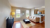 This well-appointed 2-bedroom, 2-bathroom single-floor home in New Albany, Columbus, Ohio offers a thoughtfully designed layout that maximizes comfort and functionality. The open-concept living, dining, and kitchen area serves as the heart of the home, featuring rich hardwood flooring, neutral warm-toned walls, and multiple large windows that bathe the space in abundant natural light while offering pleasant outdoor views of the surrounding greenery.

The galley-style kitchen is efficiently designed with warm wood cabinetry, dark countertops, stainless steel appliances, and a pass-through opening that connects seamlessly to the living and dining area. Both bedrooms are carpeted and well-sized, with the primary bedroom offering generous proportions, large windows with tree-lined views, and ample closet space. The second bedroom is equally bright and comfortable.

The two bathrooms are finished with wood vanities, dark countertops, and tile flooring. One bathroom features a full tub-shower combination, while the other serves as a more compact powder-style bath. Additional practical features include in-unit laundry, a hallway connecting the main spaces, and four closets providing excellent storage throughout. The overall ambiance is clean, modern, and move-in ready.