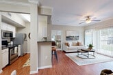 Located at 5045 Crenshaw Rd in Pasadena, TX, this single-story 2-bedroom, 2-bathroom home offers a thoughtfully designed open-concept layout. Rich hardwood-style flooring flows throughout the main living areas, complemented by neutral tones and crown molding detailing.

The living room is bright and welcoming, featuring a ceiling fan and large sliding glass doors that invite natural light and outdoor views. It connects seamlessly to a defined dining area, highlighted by track lighting and a decorative wall niche with dark countertop built-ins. The galley-style kitchen is well-equipped with stainless steel appliances, dark granite countertops, white cabinetry, and a breakfast bar with barstool seating.

The primary bedroom offers a comfortable retreat with plush carpeting, a ceiling fan, and a walk-in closet with built-in wire shelving. The bathrooms feature dark granite vanity tops, white cabinetry, and hardwood-style flooring, with one bath including a full soaking tub. A dedicated laundry area houses a full-size washer and dryer. Two closets and three hallways provide ample storage and easy circulation throughout this efficiently organized home.