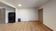 Located at 650 SE 162nd Ave in Portland, OR, this apartment offers a practical and well-designed single-floor layout with two bedrooms, one bathroom, and three closets. The open-concept main living area seamlessly combines the living room, dining room, and kitchen into one cohesive space. A ceiling fan overhead and a baseboard heating system ensure year-round comfort, while recessed and flush-mount lighting brighten the interior. Large windows in the living area invite natural light and offer outdoor views of the surrounding neighborhood.

The kitchen is a standout feature, equipped with rich dark-wood cabinetry, granite-style countertops, a black electric range with overhead ventilation, a dishwasher, and a refrigerator. Ample counter and cabinet space make it highly functional.

Both bedrooms continue the consistent luxury vinyl plank flooring found throughout the unit. Each room includes a ceiling fan, a dedicated closet, and windows that bring in natural light. The primary bedroom is generously sized, offering comfortable proportions.

The bathroom is designed with accessibility in mind, featuring stainless steel grab bars near the toilet and bathtub/shower combo, along with a window for natural ventilation. A hallway connects the main living areas to the bedrooms, completing this efficiently laid-out home.