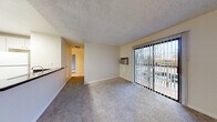 Located at 201 Ryan Dr in Pleasant Hill, CA, this single-floor residence offers a well-organized layout designed for comfortable everyday living. The living area features plush carpeting, a wall-mounted air conditioning unit, and a sliding glass door fitted with vertical blinds that opens to a private balcony, allowing natural light and outdoor views to filter into the space. A ceiling fan adds to the room's functionality. The kitchen is efficiently designed with white cabinetry, dark countertops, wood-look flooring, and white appliances including a range and refrigerator. A pass-through counter connects the kitchen to the living space, creating an open, communicative feel between the two areas. The bedrooms are generously proportioned, each featuring soft carpeting, neutral walls, and windows with vertical blinds that bring in natural light while offering views of the surrounding landscape. Baseboard heating is present in the bedrooms for added comfort. The bathroom area includes a wide vanity with dark countertops, white cabinetry, a large mirror with overhead lighting, and access to an additional bathroom space. Textured ceilings are consistent throughout, lending a cohesive character to the entire residence.