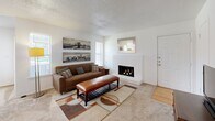 This single-story, two-bedroom, two-bathroom home in Wichita Falls, TX offers a well-organized layout designed for comfortable everyday living. The inviting living room serves as the heart of the home, featuring a classic white brick wood-burning fireplace, neutral carpet, and windows that bring in natural light. Adjacent to the living area, the galley-style kitchen is outfitted with white cabinetry, light countertops, a double sink, and hardwood-style flooring, providing a clean and functional cooking space. The separate dining room offers a bright and open setting with a window overlooking the surrounding landscape. The spacious primary bedroom includes a ceiling fan, carpeted floors, and ample room for furnishings, while the second bedroom also features carpet and a window with natural light. Each bedroom benefits from dedicated closet space. The two bathrooms are well-appointed with shower-tub combinations, white vanities, and easy-to-maintain finishes. A connecting hallway ties the private quarters together seamlessly. Textured ceilings are consistent throughout, contributing to the home's classic character. Located near Weeks Park, this residence offers convenient access to green space and community amenities.