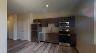 Located at 626 Lehman St in Columbus, Ohio's vibrant 43206 zip code, this single-floor unit offers a clean, contemporary design with thoughtful finishes throughout. The open-concept living and dining area is bright and welcoming, benefiting from natural light streaming through large windows with horizontal blinds, and is complemented by wood-look plank flooring and ceiling fans that add both comfort and style.

The kitchen is well-appointed with rich, dark wood laminate cabinetry extending from floor to ceiling, providing generous storage. A full suite of stainless steel appliances — including a refrigerator, electric range, over-the-range microwave, and dishwasher — is paired with a tiled backsplash and a single-basin sink, creating a functional and attractive cooking space that opens directly to the living area.

The bathroom features a full tub-shower combination with built-in shelving, a dark wood vanity with a granite-style countertop, an undermount sink, and a large mirror, all set on the same wood-look flooring found throughout the unit. Neutral, warm-toned walls carry consistently across every room, lending the space a cohesive and move-in-ready aesthetic. The overall layout is efficient and well-organized, making excellent use of the available footprint.