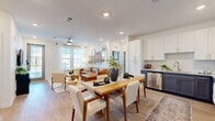 Located at 8353 Auterra Drive in Melbourne, FL, this well-appointed 2-bedroom, 2-bathroom residence combines modern design with functional living across a single, thoughtfully organized floor. The heart of the home is a seamlessly connected open-concept living, dining, and kitchen area bathed in natural light from multiple windows. The kitchen features crisp white shaker cabinetry, contrasting navy lower cabinets, granite countertops, and a full suite of stainless steel appliances, including a French door refrigerator, range, microwave, and dishwasher. Light wood-tone flooring flows throughout, enhancing the bright, airy atmosphere. The living area is anchored by large windows and a ceiling fan, while the adjacent dining space offers a comfortable setting for everyday meals or entertaining. The spacious primary bedroom features an accent wall, natural light, and access to a well-appointed en suite bathroom with dual sinks, granite countertops, and a walk-in closet with built-in shelving. The second bathroom includes a full soaking tub and shower combination with clean white tile finishes. Five closets provide exceptional storage throughout. Additional features include a private balcony, a dedicated laundry area, and a utility room, rounding out this complete and modern Melbourne residence.