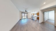 Located at 8150 Rafael Rivera Way in Las Vegas, NV, this thoughtfully designed two-bedroom, one-bathroom residence offers a clean, modern aesthetic throughout its efficiently utilized single-floor layout. The open-concept living and kitchen area is anchored by warm wood-tone cabinetry, a white quartz kitchen island illuminated by pendant lighting, stainless steel appliances, and a tiled backsplash. Light wood-style flooring flows through the main living area, complemented by a ceiling fan and a sliding glass door that opens to a private balcony, filling the space with natural light. The primary bedroom features plush carpeting, a ceiling fan, and access to a well-organized walk-in closet with built-in shelving and hanging rods. The second bedroom also offers wood-style flooring, a ceiling fan, and balcony access. The full bathroom is finished with clean white walls, wood-style flooring, a combination tub and shower, and a warm wood vanity with ample counter space. A dedicated laundry area with in-unit washer and dryer adds everyday convenience. The overall ambiance is bright, contemporary, and functional, making for a comfortable residence in the heart of Las Vegas.