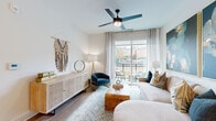 Located in Atlanta, GA, this well-appointed one-bedroom, one-bathroom residence offers a cohesive modern design with warm wood-tone accents and light neutral walls throughout. The open-concept kitchen and living area serves as the heart of the home, where a galley-style kitchen impresses with stainless steel appliances, white lower cabinetry paired with natural wood upper cabinets, a classic white subway tile backsplash, and a central island with a quartz countertop that doubles as a casual dining and prep space. A sleek linear pendant light anchors the kitchen, while light-toned hardwood flooring flows seamlessly through the entire unit. The living room is bathed in natural light from a large sliding glass door that opens to a private balcony with outdoor views of the surrounding neighborhood. A ceiling fan with modern blades adds both style and function overhead. The bedroom offers a serene retreat with a generous window, access to a dedicated closet, and warm, understated finishes. The bathroom features a wood-grain vanity with a white countertop, an illuminated mirror, marble-look tile flooring, and a sleek walk-in shower, creating a clean, spa-inspired feel. Every detail of this residence reflects a thoughtful, contemporary aesthetic.