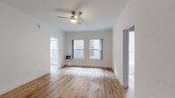 Located at 520 S Mariposa Ave in the Koreatown neighborhood of Los Angeles, this single-floor unit offers a thoughtfully updated interior with a cohesive, contemporary aesthetic throughout. Light wood laminate flooring runs continuously across all rooms, creating a warm and unified feel from entry to bedroom.

The main living area is open and airy, with crisp white walls, a ceiling fan with integrated lighting, and multiple windows that allow natural light to fill the space. A wall-mounted gas heater provides supplemental heating. The layout connects fluidly to the bedroom, which mirrors the living area's clean design and also features a ceiling fan and generous wall space.

The kitchen is well-appointed with gray shaker-style cabinetry, white quartz countertops, a stainless steel gas range, an under-cabinet range hood, and a single-basin stainless steel sink. The cabinetry offers ample upper and lower storage, making the kitchen both functional and visually polished.

The bathroom maintains the home's bright, minimalist character with all-white finishes, a subway tile soaking tub with an overhead shower, a single-sink vanity with cabinet storage, and a window for natural ventilation. The wood flooring extends into this space as well, reinforcing the unit's consistent design language throughout.