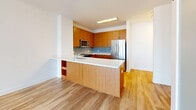 Located in Chicago's vibrant River North neighborhood, this one-bedroom, one-bathroom residence offers a well-designed layout that maximizes both comfort and functionality. The open-concept living, dining, and kitchen area is anchored by light hardwood flooring and floor-to-ceiling windows that flood the space with natural light and frame dramatic skyline views. A sliding glass door leads to a private balcony, extending the living space outdoors with sweeping vistas of the surrounding cityscape.

The kitchen is outfitted with warm-toned wood cabinetry, light countertops, a subway tile backsplash, and a full suite of stainless steel appliances including a gas range, over-the-range microwave, dishwasher, and a full-size refrigerator. A peninsula with seating provides a natural division between the kitchen and living areas.

The bedroom is carpeted for comfort and features a corner configuration of floor-to-ceiling windows, delivering expansive city views and abundant natural light. Two closets provide generous storage. The bathroom includes a soaking tub with clean subway tile surround and a tasteful accent border. A dedicated laundry area adds everyday convenience to this well-appointed urban residence.