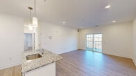Located at 111 Sunset Cir in Camden, Delaware, this single-floor, 2-bedroom, 2-bathroom residence offers a clean, modern design with thoughtful finishes throughout. The open-concept kitchen and living area serves as the heart of the home, where a well-equipped kitchen features white shaker cabinetry, granite countertops, a subway tile backsplash, stainless steel appliances, and a central island with pendant lighting. Light wood-style flooring flows through the main living areas, and sliding glass doors open onto a private balcony, filling the space with natural light and offering outdoor views. The spacious primary bedroom is carpeted for comfort and includes a ceiling fan, ample closet space, and an en-suite bathroom. The second bedroom also features carpet, a ceiling fan, and a window for natural light. Both bathrooms are finished in a clean, bright style—one with a tub/shower combo and a white vanity, and the other with a walk-in shower. Four closets provide generous storage throughout. A dedicated laundry area adds everyday convenience. The overall ambiance is bright, fresh, and move-in ready, with a cohesive neutral palette that suits a variety of personal styles.
