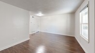 Located at 1386 Court Ave in Memphis, TN, this efficient one-bedroom, one-bathroom unit offers a well-organized layout across a single floor. The living room greets you with rich, dark hardwood flooring, crisp white walls, and a textured ceiling, creating a clean and functional space with room for comfortable furnishings. A dedicated utility area adds practical convenience to the layout. The kitchen is thoughtfully designed with white cabinetry, a slate-blue subway tile backsplash, granite countertops, and a built-in breakfast bar extension — ideal for casual dining. White appliances, including a range and refrigerator, complete the functional cooking space. The bedroom features light tile flooring, neutral walls, and a window that allows natural light to brighten the room. Direct access to the bathroom and an adjacent room provide added versatility. The bathroom showcases large-format, marble-look porcelain tile surrounding the bathtub, offering an elevated aesthetic. Throughout the unit, the consistent use of neutral tones and clean finishes creates a cohesive, move-in-ready environment suited for straightforward, comfortable living in the heart of Memphis.