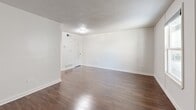 Located at 1386 Court Ave in Memphis, TN, this efficient one-bedroom, one-bathroom unit offers a well-organized layout across a single floor. The living room greets you with rich, dark hardwood flooring, crisp white walls, and a textured ceiling, creating a clean and functional space with room for comfortable furnishings. A dedicated utility area adds practical convenience to the layout. The kitchen is thoughtfully designed with white cabinetry, a slate-blue subway tile backsplash, granite countertops, and a built-in breakfast bar extension — ideal for casual dining. White appliances, including a range and refrigerator, complete the functional cooking space. The bedroom features light tile flooring, neutral walls, and a window that allows natural light to brighten the room. Direct access to the bathroom and an adjacent room provide added versatility. The bathroom showcases large-format, marble-look porcelain tile surrounding the bathtub, offering an elevated aesthetic. Throughout the unit, the consistent use of neutral tones and clean finishes creates a cohesive, move-in-ready environment suited for straightforward, comfortable living in the heart of Memphis.