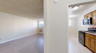 Located at 1 Chester Cir in New Brunswick, NJ, this 2-bedroom, 1-bathroom unit offers a practical and well-organized single-floor layout. The interior features light-toned tile-look flooring throughout the main living areas, complemented by textured ceilings that add a classic character to each room. Natural light filters in through windows in the living and bedroom areas, keeping the space bright and welcoming.

The living room is generously sized with a clean, open feel, flowing into a dedicated dining area and a functional kitchen. A central hallway connects the main living spaces to the bedrooms and bathroom, providing an efficient traffic flow. The primary bedroom is a comfortable size, featuring a window, baseboard heating, and two closets with paneled doors — ideal for organized storage. The second bedroom also includes a window and baseboard heating, maintaining a consistent, comfortable feel throughout.

The bathroom is well-appointed with beige tile surround, a mosaic tile accent border, a tub-shower combination, a wood-toned vanity with a white countertop, and white tile flooring. With five closets distributed throughout the unit, storage is a notable strength of this home. The neutral color palette and clean finishes provide a versatile backdrop for any décor style.