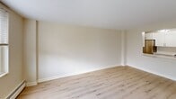 This 940 square foot apartment, located at 700 Huron Ave in Cambridge, MA, offers a blend of comfort and functionality. The space features five bedrooms, including a primary bedroom of 150 square feet, and two bathrooms. The single-floor layout promotes easy navigation and efficient use of space.

The apartment showcases modern renovations throughout, with a neutral color palette and light wood flooring creating a bright, airy atmosphere. Large windows in the bedrooms and living areas flood the space with natural light, while also offering pleasant views of the surrounding area.

The kitchen is compact yet well-designed, featuring white cabinetry, sleek countertops, and stainless steel appliances. The living room provides a versatile space for relaxation and entertainment. The bathrooms are updated with contemporary fixtures and marble-like tiling, adding a touch of elegance.

Each bedroom offers ample space and includes convenient features such as built-in closets and individual climate control units. The apartment's layout, with its two hallways, ensures privacy and easy flow between rooms.

Overall, this apartment combines modern amenities with a practical layout, making it an ideal living space in the heart of Cambridge.