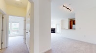 Located at 386 Attenborough Dr in Rosedale, Maryland, this single-floor residence offers a thoughtfully designed layout that balances comfort and functionality. The open-concept living area is a central highlight, featuring plush neutral carpeting, recessed and track lighting, and a classic fireplace flanked by large windows that invite an abundance of natural light and offer pleasant outdoor views. The space flows seamlessly into a semi-open kitchen, where warm wood cabinetry, a breakfast bar counter, light countertops, and stainless steel appliances — including a gas range and refrigerator — create a practical and inviting cooking environment. Tile flooring in the kitchen adds a clean contrast to the carpeted living spaces. The hallway connects the main living areas to the private quarters, featuring multiple closets with paneled doors for generous storage. The bedrooms are carpeted and well-proportioned, offering a calm retreat with easy access to the bathrooms. The bathrooms are clean and functional, with one featuring warm wood vanity cabinetry, tile flooring, and a tub-shower combination, while another offers a dual-sink vanity setup. Throughout the home, a neutral color palette and consistent design choices create a cohesive and welcoming ambiance.