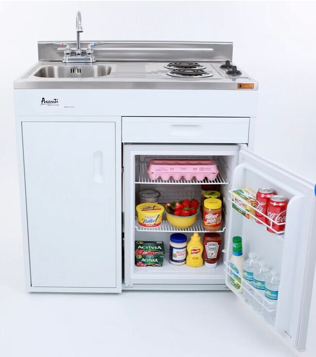 Brand new kitchenette with sink, stove, refrigerator, and storage space. - 9970 SW 20th St