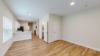 Located at 833 E Davis St in Sullivan, Indiana, this two-story home offers a thoughtfully designed layout spread across two floors. The main level provides a generous living area with light-toned luxury vinyl plank flooring, recessed lighting, and a neutral color palette that creates a bright, welcoming atmosphere. The open-concept kitchen flows seamlessly into the living room and features white shaker-style cabinetry, marble-look countertops with a breakfast bar peninsula, a stainless sink, and black appliances — combining style with functionality. Natural light filters in through multiple windows fitted with white blinds throughout the home. The main floor also includes a hallway, a bathroom, and access to a dedicated laundry room equipped with a full-size washer and dryer. Upstairs, the second floor hosts the remaining bedrooms and bathrooms. The spacious primary bedroom spans a comfortable footprint, while additional bedrooms offer hardwood-style or carpeted flooring with ample natural light and closet access. The bathrooms are finished with hardwood-style flooring, vanities with grey cabinetry, and tub-shower combinations. A utility room and multiple closets round out the practical amenities of this well-equipped home.