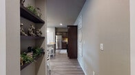 Located at 750 S Promenade Blvd in Rogers, Arkansas, this single-story residence offers a thoughtfully designed layout with modern finishes throughout. Wood-look plank flooring flows seamlessly across the entire unit, creating a cohesive and contemporary aesthetic.

The kitchen is a standout feature, showcasing rich dark espresso cabinetry, granite countertops, stainless steel appliances, and a large island with bar seating. Pendant lighting illuminates the workspace, and a dedicated dining area sits adjacent, making the space ideal for both everyday living and entertaining.

An entry hallway with open floating shelves leads into the main living area, which is bright and inviting with a ceiling fan and large windows fitted with blinds that allow natural light to filter in softly. The living room provides a comfortable, relaxed setting.

The primary bedroom is a serene retreat with a ceiling fan, natural light from a window, and ample floor space. Its en suite bathroom features dark cabinetry, a walk-in shower, and access to a walk-in closet. A second bedroom offers similar comfort with a window and generous proportions. The second bathroom mirrors the refined finishes found throughout, with dark vanity cabinetry and clean, neutral tones. The overall ambiance is warm, modern, and move-in ready.
