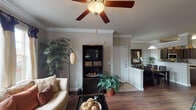 This single-story 1-bedroom, 1-bathroom residence in Conroe, Texas is thoughtfully designed to maximize comfort and functionality. The open-concept living area features rich hardwood-style flooring, crown molding, and a ceiling fan, creating a warm and inviting atmosphere. Large windows allow natural light to fill the space, enhancing the neutral, contemporary color palette throughout.

The kitchen is well-appointed with dark espresso cabinetry, granite-style countertops, stainless steel appliances including a refrigerator, range, and built-in microwave, and a double-basin sink. A breakfast bar with a raised counter connects the kitchen to the dining area, making it ideal for casual dining or entertaining.

The bedroom is generously sized, featuring plush carpeting, a ceiling fan, and a sliding glass door that opens to an outdoor area, allowing natural light and outdoor views. A walk-in closet provides ample storage.

The bathroom is elegantly finished with dark vanity cabinetry, a white countertop, a full-size soaking tub with tile surround, recessed lighting, and an adjacent walk-in closet with louvered doors. Throughout the unit, cohesive design elements and quality finishes contribute to a polished, comfortable living environment.