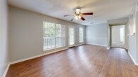Located at 906 Galaxy Dr in Jackson, Tennessee, this single-floor residence offers a well-organized layout with a variety of functional and comfortable living spaces. The living room is a standout area, featuring warm hardwood flooring, a ceiling fan with light fixture, and a textured ceiling. Large windows and a glass door flood the room with natural light and provide direct access to a private outdoor balcony, offering pleasant views of surrounding greenery.

The kitchen is thoughtfully designed with marble-look countertops, white upper cabinetry, gray lower cabinetry, and a full suite of black appliances including a range, built-in microwave, and dishwasher. A stainless steel sink with a modern faucet completes the space.

The bedrooms are finished with plush carpet and ceiling fans, creating a cozy atmosphere. Each room benefits from multiple windows that bring in natural light. One bedroom features a spacious walk-in closet with built-in shelving, offering generous storage capacity.

The bathroom is clean and functional, with tile flooring, a shower-tub combination, a vanity with a marble-look countertop, dark cabinetry, and a well-lit mirror. A dedicated laundry area houses a full-size washer and dryer, adding everyday convenience to this practical and comfortable home.