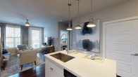 Located in the vibrant Swiss Avenue corridor of Dallas, TX, this single-floor residence offers a thoughtfully designed open-concept layout that seamlessly connects the kitchen, dining, and living areas. The kitchen is a standout feature, showcasing white shaker cabinetry, quartz countertops, a large center island with an undermount sink and a sleek coil-neck faucet, stainless steel appliances, and a subway tile backsplash. Brushed nickel pendant lights illuminate the island, while recessed lighting brightens the full kitchen. A built-in wine rack adds a charming, functional touch. Rich dark hardwood floors run throughout the main living areas, complementing the neutral gray walls and creating a warm, contemporary ambiance. The living room is inviting and light-filled, with large windows and a glass door opening to a private balcony, a ceiling fan, and ample space for relaxed entertaining. The bedroom offers plush carpeting, generous natural light from a large window with outdoor views, and a ceiling fan. It connects to a well-appointed bathroom featuring white cabinetry, a soaking tub with shower, a walk-in closet, and a striking sliding barn door entry. Every detail of this residence reflects a refined, modern aesthetic with practical, high-quality finishes throughout.