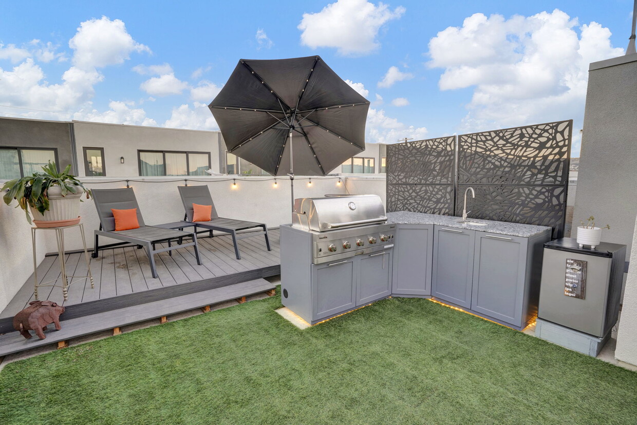 One of the best parts of the home - the gorgeous rooftop deck! With built-in grill, deck, sink. - 279 W 8th St