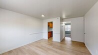 Located at 372 Beechmont Dr in Newport News, VA, this well-organized one-bedroom, one-bathroom residence makes efficient use of its single-floor layout. The living area welcomes you with clean, light-toned hardwood-style flooring that extends throughout the main living spaces, giving the unit a bright and cohesive feel. Crisp white walls and neutral tones create a clean, move-in-ready atmosphere throughout.

The kitchen is conveniently situated off the main living area and features warm honey-toned wood cabinetry paired with a functional countertop layout — compact yet practical for everyday cooking needs.

The bedroom is a comfortable, well-proportioned retreat finished with plush carpet flooring that adds warmth underfoot. A large double sliding closet provides ample storage, while a window with blinds allows natural light to filter in and offers a view of the surrounding neighborhood.

The full bathroom is finished with a clean, all-white tub and shower surround, complemented by a standard toilet and sink. A grab bar adds an accessible touch. Tile flooring completes the functional, tidy space.

Two closets throughout the unit offer additional storage options. The layout flows logically from the living area through to the bedroom and bathroom, making the space practical and easy to navigate. Central air and heating vents are present throughout, ensuring year-round comfort.
