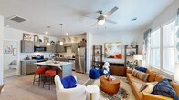 Located in Tyler, TX, this thoughtfully designed one-bedroom, one-bathroom residence offers an efficient and functional single-floor layout. The open-concept living and kitchen area forms the heart of the home, creating a seamless flow between cooking and relaxing spaces. The kitchen is outfitted with stainless steel appliances — including a refrigerator, dishwasher, microwave, and range — complemented by gray shaker-style cabinetry, granite countertops, and a center island with bar seating illuminated by pendant lighting. Wood-look flooring runs throughout the main living areas, adding warmth and continuity. The living room receives generous natural light through large windows dressed with blinds and curtains, and is finished with a ceiling fan overhead. The bedroom is a comfortable retreat featuring plush carpeting, a ceiling fan, a window for natural light, and access to a dedicated closet. The bathroom features a gray wood vanity with granite countertops, a large mirror with modern lighting, and wood-look flooring. The layout makes efficient use of every square foot, delivering a cohesive and well-finished living environment suited for comfortable day-to-day living.