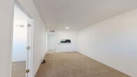 Located at 4250 E Busby Dr in Sierra Vista, Arizona, this one-bedroom, two-bathroom unit offers a practical and well-organized single-floor layout. The living room is an open, bright space finished with neutral beige carpeting and crisp white walls, creating a clean and airy atmosphere. A pass-through counter connects the living area to the kitchen, adding functionality and a sense of openness to the common areas. Recessed lighting provides consistent illumination throughout.

The bedroom is a comfortable, private space featuring the same warm carpeting, white walls, and a window fitted with blinds that allows for natural light while maintaining privacy. A dedicated closet provides convenient storage.

The unit includes two bathrooms. The first features wood-look flooring, a full bathtub and shower combination, and a toilet. The second bathroom, accessible from the bedroom area, is equipped with a white vanity with ample cabinet storage, a sink, and a mirror, with a view into the adjacent bedroom. The consistent white color palette across all rooms lends the space a cohesive, clean aesthetic. Overall, this unit offers a straightforward, functional layout well-suited for efficient everyday living in Sierra Vista.