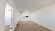 Located at 4250 E Busby Dr in Sierra Vista, Arizona, this one-bedroom, two-bathroom unit offers a practical and well-organized single-floor layout. The living room is an open, bright space finished with neutral beige carpeting and crisp white walls, creating a clean and airy atmosphere. A pass-through counter connects the living area to the kitchen, adding functionality and a sense of openness to the common areas. Recessed lighting provides consistent illumination throughout.

The bedroom is a comfortable, private space featuring the same warm carpeting, white walls, and a window fitted with blinds that allows for natural light while maintaining privacy. A dedicated closet provides convenient storage.

The unit includes two bathrooms. The first features wood-look flooring, a full bathtub and shower combination, and a toilet. The second bathroom, accessible from the bedroom area, is equipped with a white vanity with ample cabinet storage, a sink, and a mirror, with a view into the adjacent bedroom. The consistent white color palette across all rooms lends the space a cohesive, clean aesthetic. Overall, this unit offers a straightforward, functional layout well-suited for efficient everyday living in Sierra Vista.