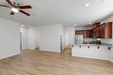 Located at 3607 Rustic Meadow Ct in Bakersfield, CA, this single-story, 3-bedroom, 2-bathroom home offers a well-designed open-concept layout. The combined kitchen and living area is bright and welcoming, featuring light wood-style flooring, recessed lighting, and a ceiling fan. Large windows flood the entry and living space with natural light, creating an airy atmosphere throughout.

The kitchen is a standout feature, equipped with rich dark wood cabinetry, granite countertops, and a full suite of stainless steel appliances including a gas range, built-in microwave, and refrigerator. A peninsula with a granite surface provides additional prep space and seating. A walk-in pantry adds convenient storage just off the kitchen.

The three bedrooms are carpeted for comfort, each equipped with a ceiling fan. The primary bedroom offers a generous footprint with a closet. The secondary bedrooms are well-sized with windows that bring in natural light.

Both bathrooms are finished with granite-top vanities and rich wood cabinetry. One bathroom features a shower/tub combination with sliding glass doors and a window above, while the other is appointed with grab bars, reflecting thoughtful accessibility design. Light wood-style flooring runs through both bathrooms, tying the home's finishes together cohesively.