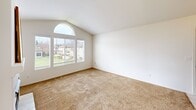 Located at 1325 E Foxhill Dr in Fresno, CA, this single-story, one-bedroom, one-bathroom unit offers a thoughtfully organized layout across a comfortable footprint. The living room serves as the centerpiece of the home, showcasing vaulted ceilings that lend a sense of openness and volume. A tile-surround fireplace anchors one wall, while a large arched window flanked by additional panes floods the space with natural light and provides views of the surrounding neighborhood. Soft carpeting throughout the living area adds warmth underfoot.

The dining area is a distinct, dedicated space featuring tile flooring, a ceiling fan, and tall windows that continue the home's emphasis on natural light. It connects smoothly to the rest of the unit via two hallways, contributing to an efficient and functional flow.

The primary bedroom is generously sized, featuring vaulted ceilings, soft carpet, and a walk-in closet with built-in shelving — offering ample storage. The full bathroom includes a tub and shower combination with sliding glass doors, a tile-topped vanity with wood cabinetry, and tile flooring. Throughout the unit, a neutral white palette creates a clean, cohesive aesthetic.