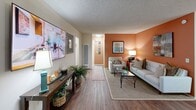Located at 1401 S Harbor Blvd in La Habra, California, this single-story residence offers a thoughtfully designed layout across one floor. The living room serves as a welcoming centerpiece, featuring warm wood-style flooring, a textured ceiling, and a striking accent wall in a rich terracotta tone that adds warmth and character to the space. Vertical blinds allow for adjustable natural light, and the room flows seamlessly toward the hallway and entry.

The galley-style kitchen is efficiently organized, with honey-toned wood cabinetry extending to the ceiling, a skylight-style overhead fixture, light countertops, and a full suite of white appliances including a gas range, microwave, and refrigerator. A double-basin stainless steel sink and wood-style flooring complete the functional yet inviting space.

The generously sized primary bedroom features plush carpeting, a soft sage accent wall, and large sliding glass doors with vertical blinds that invite natural light. A dedicated closet provides storage convenience.

The bathroom is well-equipped with a single-sink vanity featuring wood cabinetry, a large mirror, and a combined tub and shower enclosure with sliding glass doors. Wood-style flooring ties the space together cohesively throughout the home.