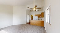 Located at 2200 Las Brisas Way in Sierra Vista, Arizona, this two-bedroom, two-bathroom unit offers a practical and comfortable single-floor layout. The living areas are finished with neutral-toned carpet throughout, complemented by crisp white walls that create a clean, bright atmosphere. Notably, several rooms feature vaulted ceilings that lend a sense of openness well beyond what the footprint might suggest. Windows in the bedrooms invite natural light and provide views of the surrounding greenery. The primary bedroom is a well-proportioned retreat, while the second bedroom also benefits from natural light and direct closet access. Each bedroom is served by its own dedicated closet for convenient storage. The two bathrooms offer distinct configurations — one includes a walk-in shower with a built-in corner bench, while the other features a full bathtub and vanity with a large mirror. The kitchen is equipped with warm wood-toned cabinetry, a white electric range, and a full-size refrigerator, all set over easy-care hardwood flooring. The floorplan overview reveals a thoughtful layout that efficiently connects the kitchen, living, and bedroom spaces throughout the home.