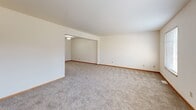 Located at 3079 E Springview Dr in Holland, Michigan, this 2-bedroom, 1-bathroom unit offers a well-organized single-floor layout with a functional and comfortable design throughout.

The kitchen is a standout feature, showcasing gray shaker-style cabinetry, a white subway tile backsplash, light quartz countertops, and a full suite of stainless steel appliances including a gas range, built-in microwave, dishwasher, and refrigerator. Light wood-look flooring completes the modern aesthetic.

The spacious living area features plush gray carpeting and a wide, open layout with a connected dining space, allowing for flexible furniture arrangements. Natural light flows in through multiple windows with vertical blinds.

The primary bedroom is generously sized and includes a walk-in closet equipped with wire shelving for organized storage, along with a sliding door closet. A second bedroom offers carpeted floors, a window with exterior views, and a standard closet. Both rooms feature warm wood-toned trim and neutral walls.

The bathroom is clean and functional, featuring a full soaking tub with a shower, a curtain rod, vinyl wood-look flooring, and a vanity. A hallway connects all rooms efficiently, completing this well-appointed and move-in-ready layout.