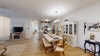 Located at 5171 Bowman Rd in Macon, GA, this charming single-story, 3-bedroom, 2-bathroom home showcases a cohesive farmhouse-inspired aesthetic throughout. Light wood-look flooring flows seamlessly across the entire residence, creating a warm and unified feel.

The open-concept living, dining, and kitchen area serves as the heart of the home. The kitchen features grey shaker-style cabinetry reaching to the ceiling, stainless steel appliances, and a central island. The dining area offers generous space for gatherings, complete with a chandelier overhead. The living room is anchored by a built-in electric fireplace and provides a cozy retreat.

The primary bedroom is a spacious sanctuary with ample natural light and its own dedicated closet. The additional bedrooms are well-proportioned, with one offering flexibility as a home office, featuring a large window that fills the room with natural light. Both bathrooms are finished with white cabinetry, clean countertops, and light wood flooring.

A dedicated laundry room with side-by-side washer and dryer adds everyday convenience. A hallway connects the bedroom wing to the main living areas, with three closets providing excellent storage throughout. The home's consistent palette of whites, naturals, and warm wood tones creates an inviting, move-in-ready atmosphere.