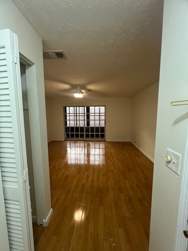 Entry way with coat closet looking into large living room - 5201 ATLANTIC Blvd