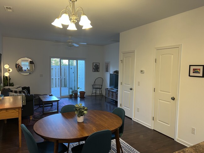 View from kitchen into dining/living rooms. Doors are half bath and coat/utility closet - 4515 Exuma Ln