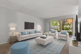 This 760 square foot apartment offers a thoughtfully designed living space with one bedroom and one bathroom. The open-concept layout maximizes the available area, creating a sense of spaciousness throughout. The living room is the heart of the home, featuring a large sliding glass door that floods the space with natural light and provides access to an outdoor area. A contemporary gray sofa, sleek coffee table, and carefully curated artwork contribute to the modern aesthetic.

The kitchen, while compact, is efficiently designed with white cabinetry, light-colored countertops, and full-sized appliances. Wood-look flooring adds warmth to the space. The bedroom, measuring 180 square feet, offers ample room for a queen-sized bed and includes a built-in closet for storage. The bathroom showcases a clean, minimalist design with a white vanity and a shower/tub combination.

Throughout the apartment, neutral tones dominate, creating a calm and cohesive atmosphere. The strategic placement of windows in various rooms ensures good natural lighting. Textured carpeting in the living areas and bedroom adds comfort underfoot. This well-planned apartment combines style and functionality, making efficient use of every square foot to provide a comfortable living space.