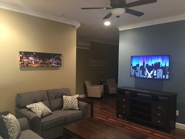 Open living room includes Roku television, ceiling fan and desk area. - 1023 Kidron Way