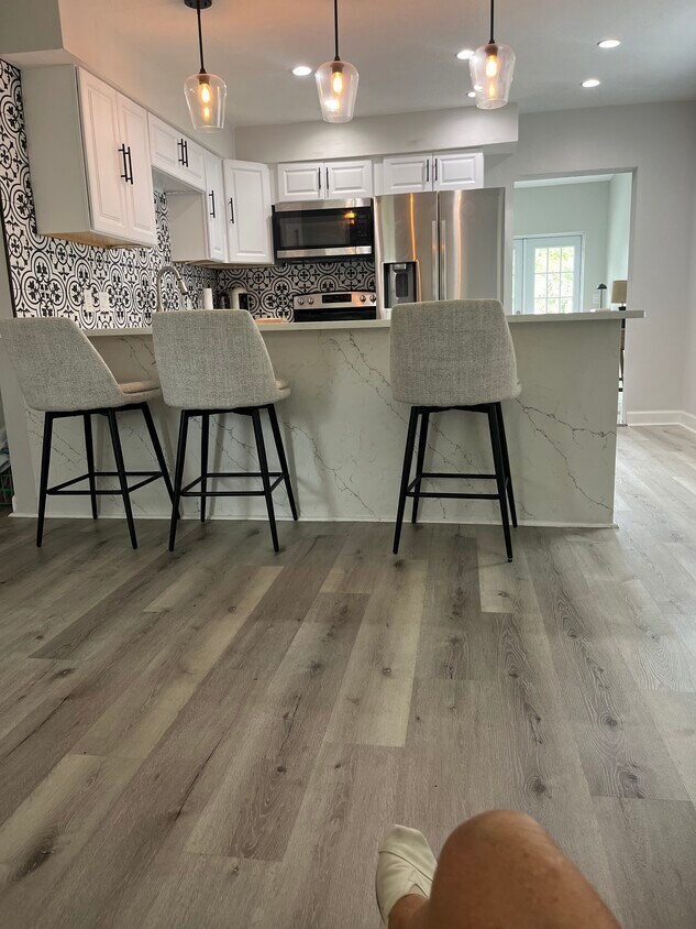 Modern fully equipped kitchen with stainless steel appliances and a wine fridge - 439 34th Ave N
