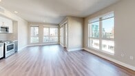 Located in the heart of Los Angeles at 215 W 14th Street, this well-appointed 2-bedroom, 2-bathroom residence offers a thoughtfully designed single-level floor plan with generous living space throughout. The open-concept kitchen and living room serves as the centerpiece of the home, featuring wide-plank hardwood-style flooring, recessed lighting, and an abundance of natural light streaming through large floor-to-ceiling windows that frame striking city skyline views. The kitchen is outfitted with stainless steel appliances, a built-in microwave, dishwasher, and refrigerator, complemented by two-tone cabinetry — white upper cabinets paired with dark lower cabinets — and a sleek tile backsplash. Both bedrooms are well-sized and bright, with the primary bedroom offering a walk-in closet. A total of four closets provide excellent storage throughout the unit. The two bathrooms are finished with modern dark wood vanities, white countertops, and tile surrounds. A dedicated in-unit laundry area with a stacked washer and dryer adds everyday convenience. The space also includes a private balcony, ideal for enjoying the urban surroundings. Neutral tones and clean lines create a contemporary, move-in-ready atmosphere throughout.