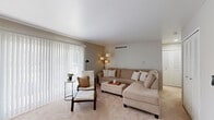 This well-appointed one-bedroom, one-bathroom residence in Davison, Michigan offers a practical and comfortable single-floor layout. The living room serves as the heart of the home, featuring plush wall-to-wall carpeting, neutral warm-toned walls, and a large sliding glass door framed by vertical blinds that floods the space with natural light and provides outdoor access. A dedicated closet and open sightlines contribute to an airy, organized feel.

The kitchen has been tastefully updated with crisp white shaker cabinetry, black hardware accents, marble-look countertops, a black undermount sink, and a white subway tile backsplash. Wood-look luxury vinyl flooring runs throughout the kitchen and dining area, complementing the black appliances including a refrigerator, range, and dishwasher. A separate dining nook provides additional functional space.

The bedroom is a comfortable retreat with soft carpeting, neutral walls, and a ceiling fan with light fixture. It offers generous closet storage with louvered double doors. The bathroom features white cabinetry with black hardware, wood-look flooring, white tile surround, and clean, modern finishes throughout. This residence combines updated aesthetics with practical living in a cohesive, well-maintained layout.