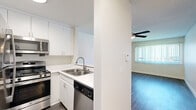 Located at 6235 Beck Ave in Los Angeles, CA, this one-bedroom, one-bathroom unit offers a thoughtfully arranged single-level floor plan that maximizes every square foot. The open-concept living area features durable wood-look flooring, a ceiling fan with light fixture, a textured ceiling, and a large window dressed with vertical blinds that invites natural light and provides exterior views. A wall-mounted AC unit ensures year-round comfort. The kitchen flows seamlessly from the living space and is equipped with white cabinetry, light countertops, a stainless steel sink, gas range, built-in microwave, dishwasher, and a stainless steel refrigerator — all framed by a convenient pass-through counter. The bedroom is carpeted for warmth and comfort, features its own ceiling fan, mirrored sliding closet doors, and a window with vertical blinds. The unit includes three closets total, offering generous storage throughout. The bathroom is clean and functional, featuring a full tub and shower combination, wood-look tile flooring, and white fixtures. The overall aesthetic is bright, neutral, and move-in ready, making this unit a practical and comfortable home in the North Hollywood neighborhood of Los Angeles.