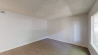 Located at 2590 Capitales Drive in Rancho Cordova, CA, this single-floor, one-bedroom, two-bathroom unit offers a practical and well-organized layout. The living room features light wood-style flooring and a large window that frames views of mature trees and the surrounding community, filling the space with natural light. A ceiling fan adds comfort and airflow to the open area adjacent to the kitchen. The kitchen is efficiently designed in a U-shaped configuration, outfitted with white cabinetry, warm-toned countertops, and white appliances including a refrigerator, electric range, dishwasher, and microwave. A window above the sink brings in additional natural light. The bedroom is a comfortable, well-proportioned room with plush carpet flooring, crisp white walls, a textured ceiling, and a window with outdoor views. A dedicated closet provides convenient storage. Both bathrooms are cleanly finished; one includes a full tub-shower combo with wood-style flooring, while the other features a vanity with warm countertops, white cabinetry, and a well-lit mirror. Textured ceilings are consistent throughout, and neutral tones create a cohesive, move-in-ready aesthetic across the entire unit.